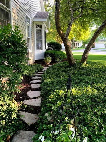 a front view of a house with a garden