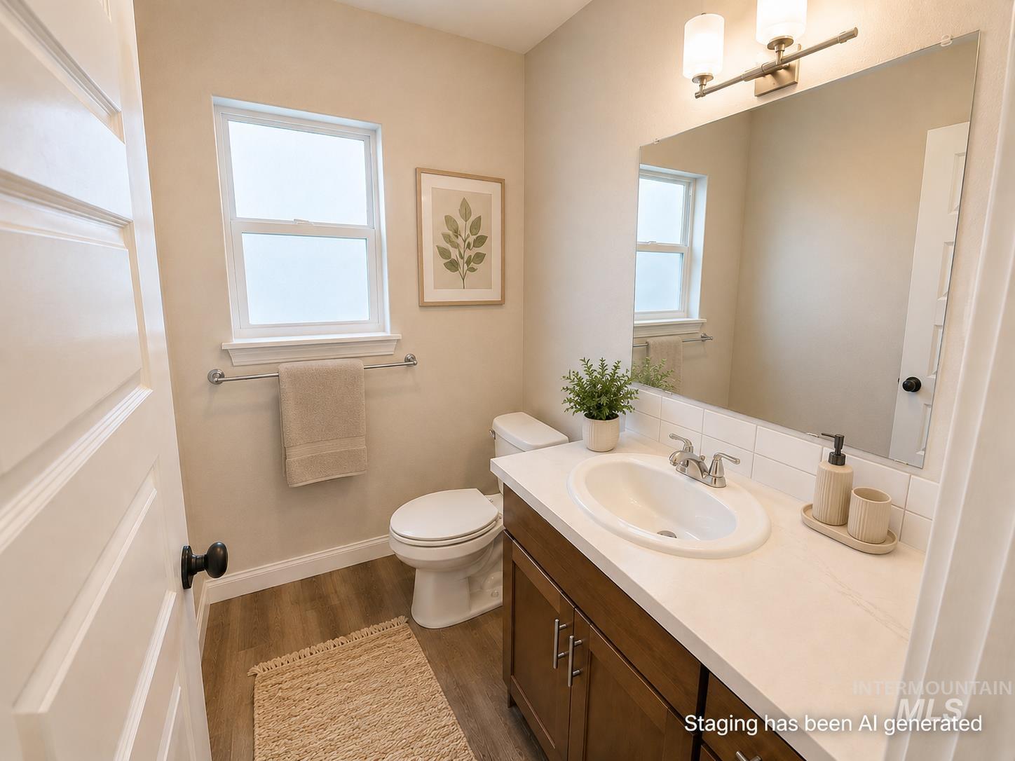983 Quartz Road Kimberly, ID 83341 - Photo 15 of 18 Wood-finish flooring, single window, vanity with integrated sink, white countertop, and wall-mounted light fixture