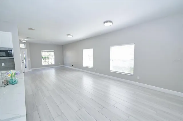 a view of a kitchen with a sink and wooden floor