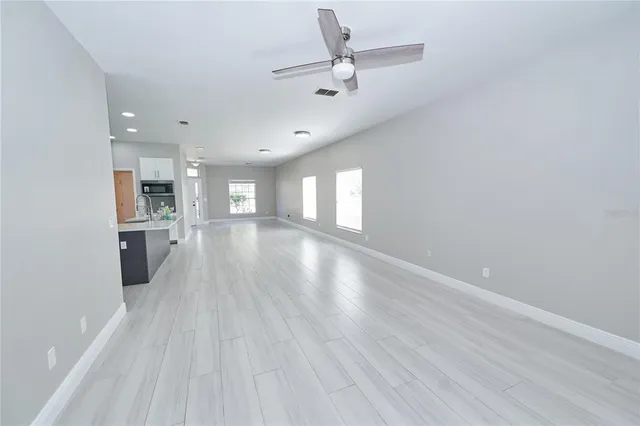 a kitchen with stainless steel appliances white cabinets and a stove top oven