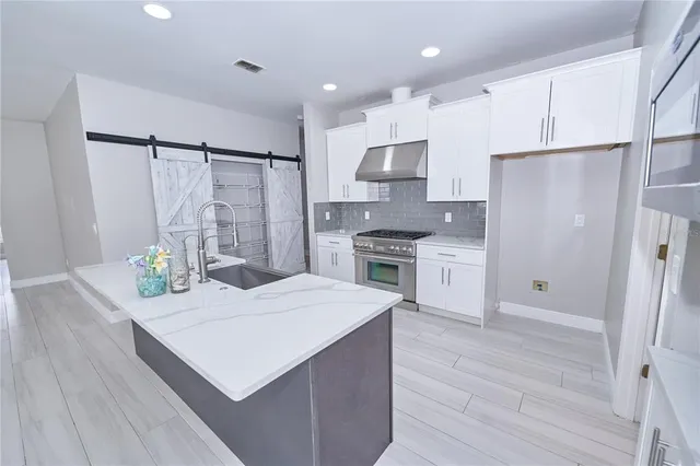 a kitchen with white cabinets and white appliances