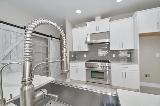 a stove top oven sitting inside of a kitchen