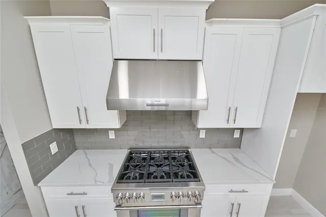 a kitchen with a sink cabinets and wooden floor