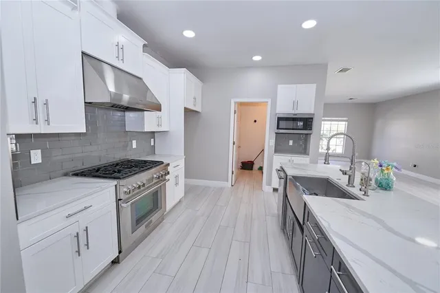 a bathroom with a double vanity sink toilet and mirror