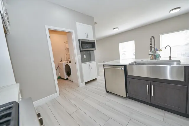 an empty room with a ceiling fan and wooden floor