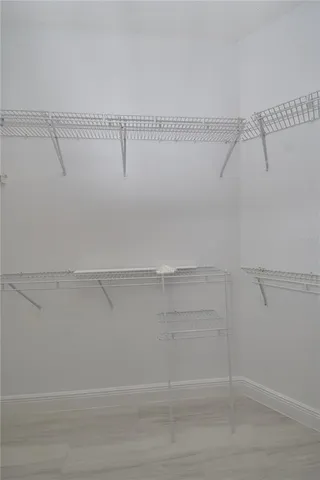 a room with a stove and a view of living room