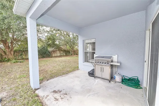 an aerial view of a house with a yard basket ball court and outdoor seating