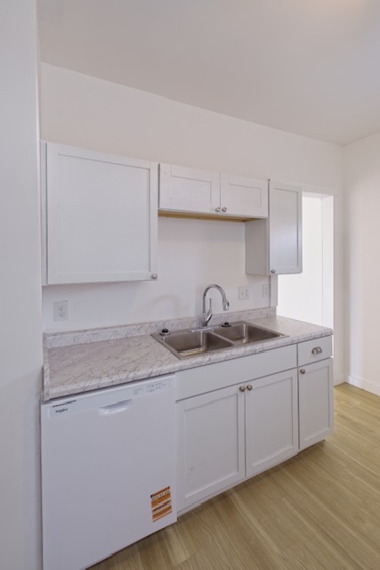 721 South 6th Street Clinton, IA 52732 - Photo 11 of 25 a kitchen with a sink and cabinets