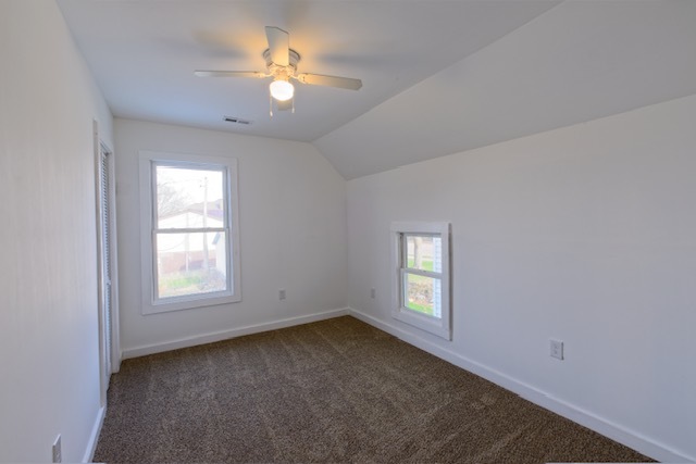 721 South 6th Street Clinton, IA 52732 - Photo 17 of 25 an empty room with windows and ceiling fan