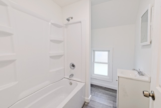 721 South 6th Street Clinton, IA 52732 - Photo 18 of 25 a white bath tub sitting next to a white sink and vanity