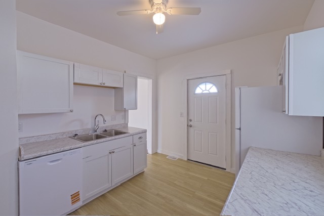 721 South 6th Street Clinton, IA 52732 - Photo 8 of 25 a kitchen with a sink cabinets and wooden floor