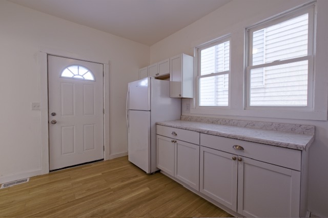 721 South 6th Street Clinton, IA 52732 - Photo 10 of 25 a view of a kitchen with cabinets and wooden floor