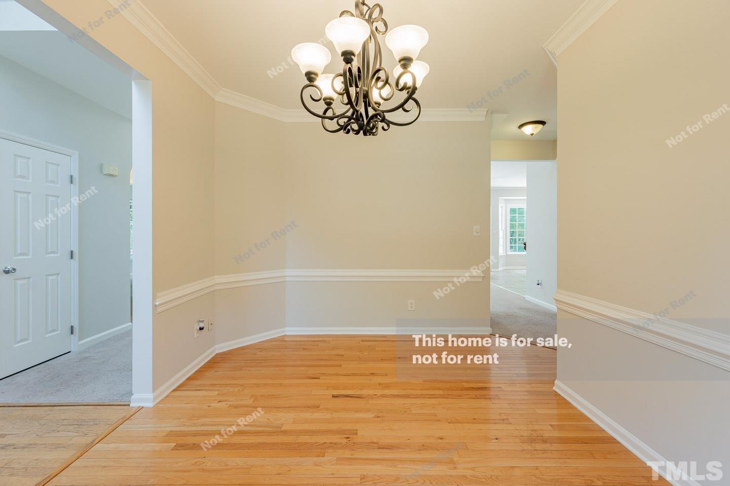 12228 Breton Lane Raleigh, NC 27613 - Photo 13 of 28 a view of a room with wooden floor and chandelier