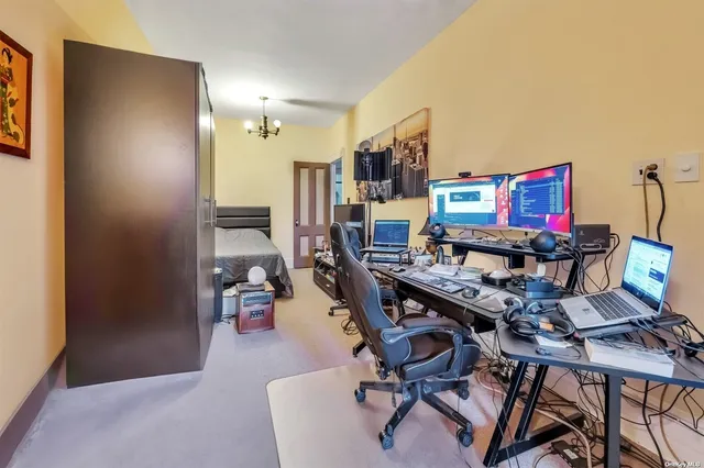 a living room with furniture and a book shelf