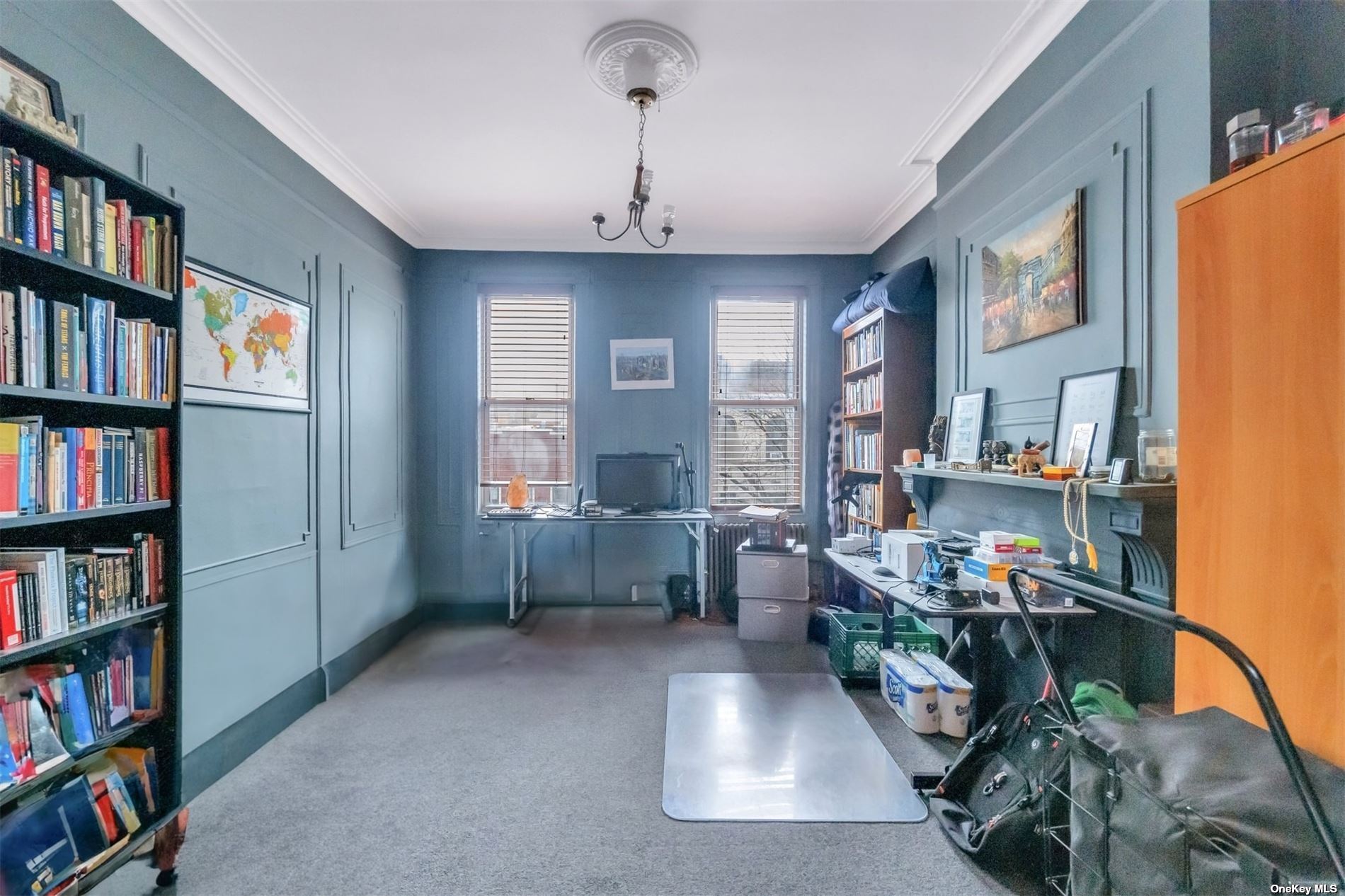 32 Sutton Street Brooklyn, NY 11222 - Photo 16 of 35 a living room with furniture and a book shelf
