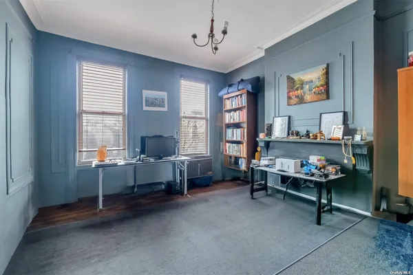 a kitchen with stainless steel appliances granite countertop a dining table chairs refrigerator and sink