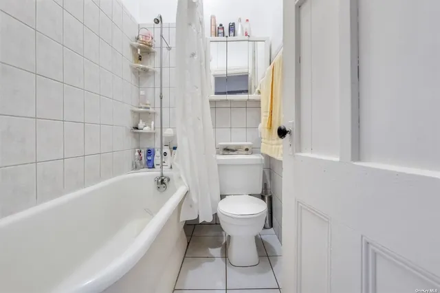 a living room with furniture and a dining table