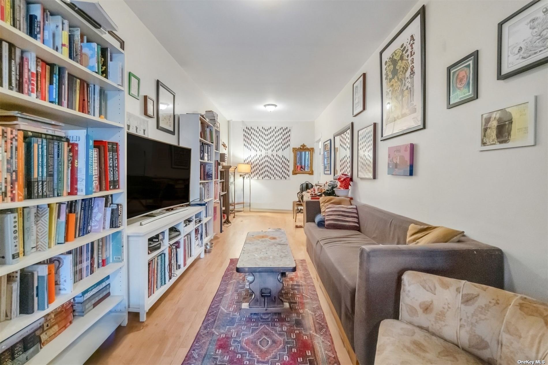 32 Sutton Street Brooklyn, NY 11222 - Photo 25 of 35 a living room with large lots of furniture and a flat screen tv
