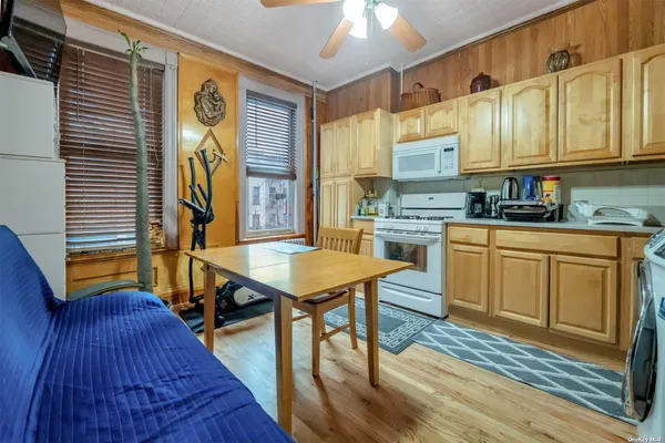 a kitchen with a stove a sink dishwasher a refrigerator and cabinets