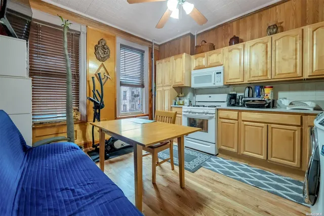 a kitchen with a stove a sink dishwasher a refrigerator and cabinets