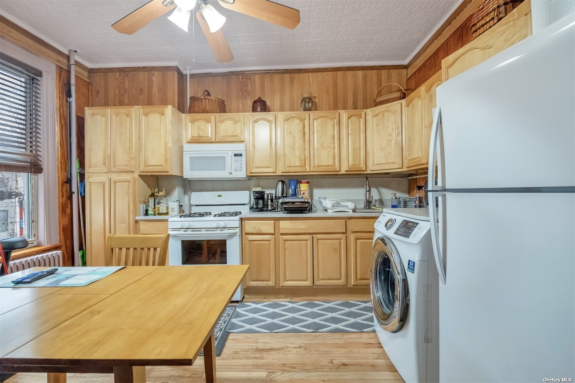 32 Sutton Street Brooklyn, NY 11222 - Photo 27 of 35 a kitchen with a stove a sink dishwasher a refrigerator and cabinets