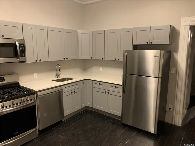 a kitchen with stainless steel appliances a refrigerator stove and microwave