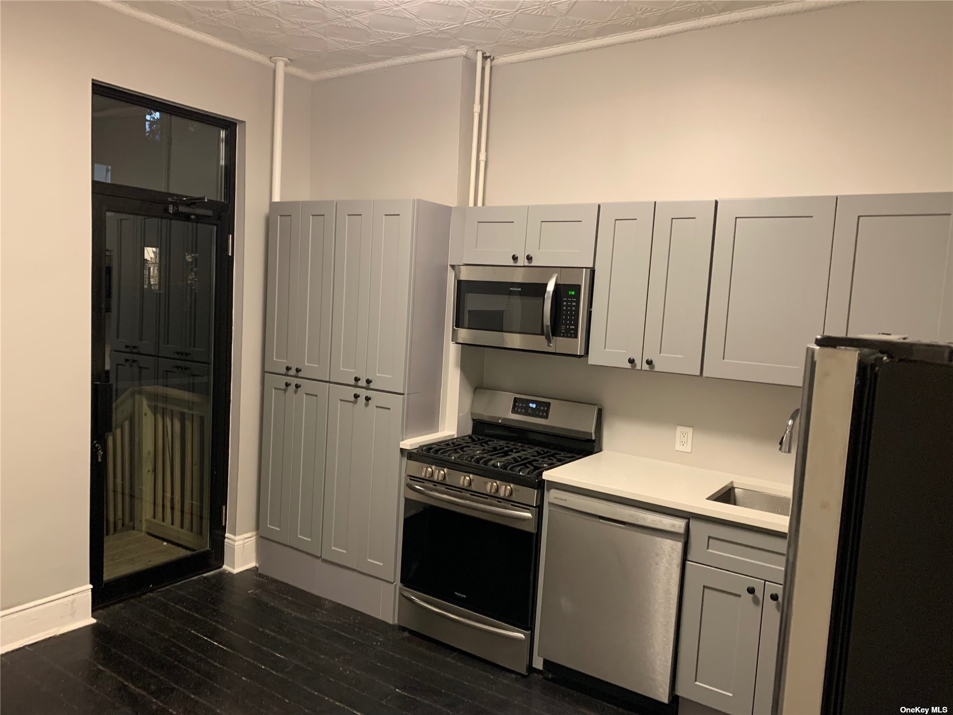 32 Sutton Street Brooklyn, NY 11222 - Photo 10 of 35 a kitchen with stainless steel appliances a refrigerator stove and microwave