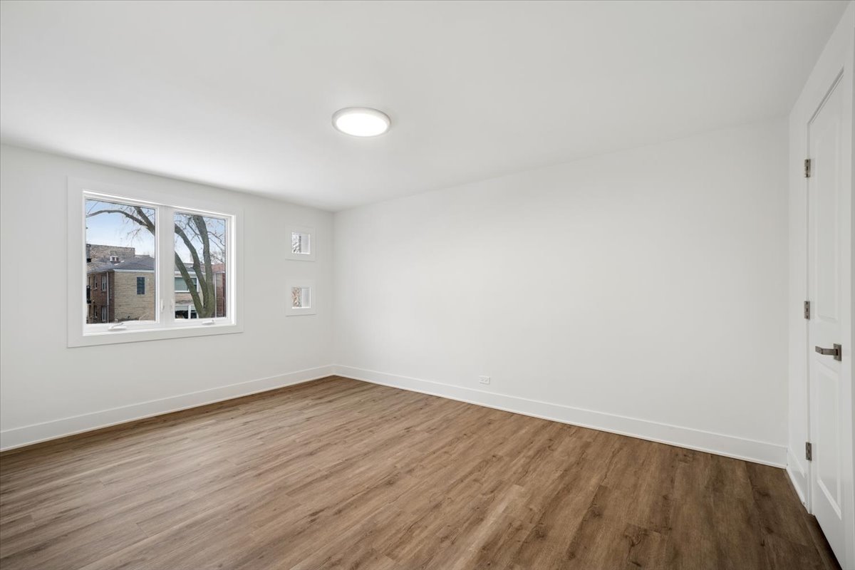 803 Brummel Street Evanston, IL 60202 - Photo 14 of 21 an empty room with wooden floor and windows