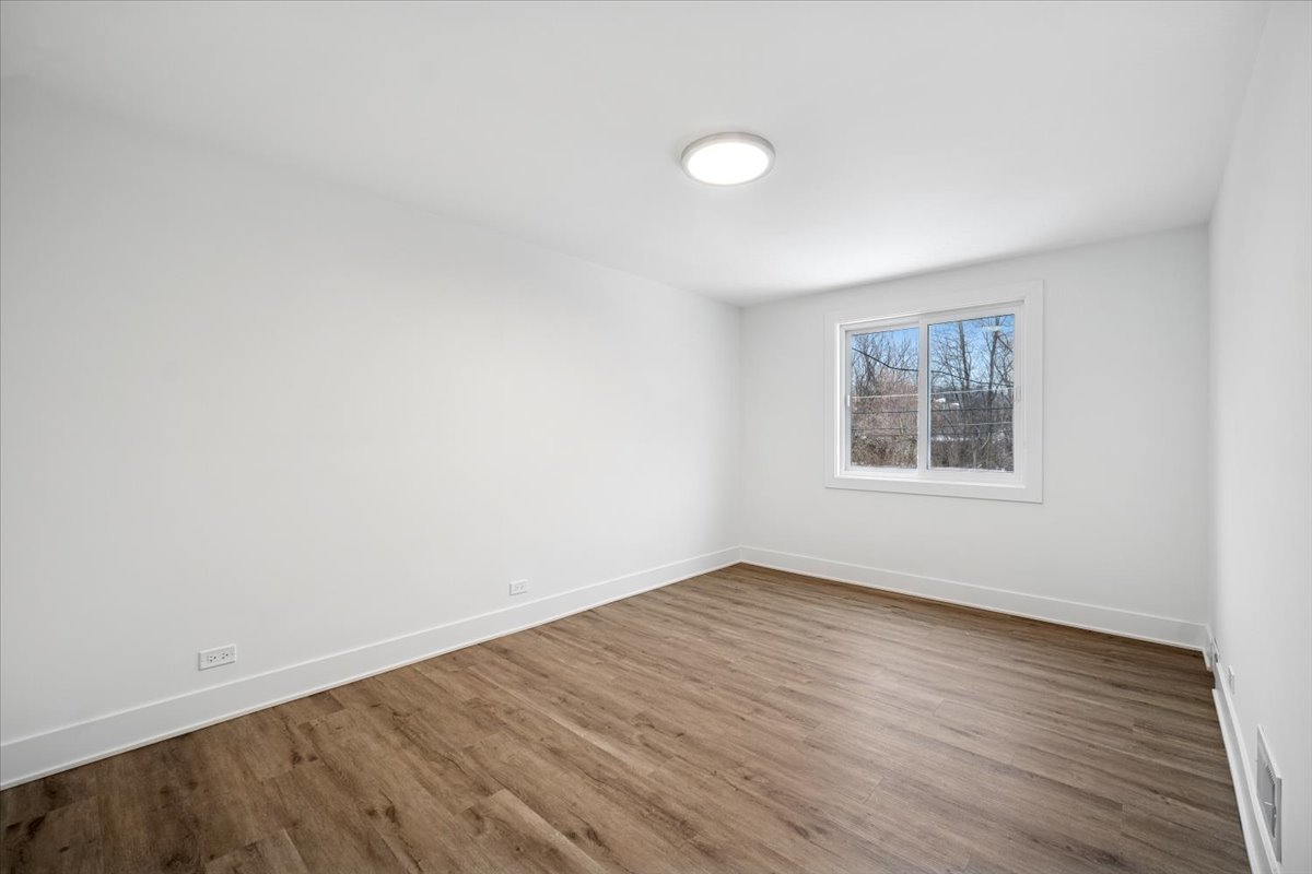 803 Brummel Street Evanston, IL 60202 - Photo 16 of 21 an empty room with wooden floor and windows