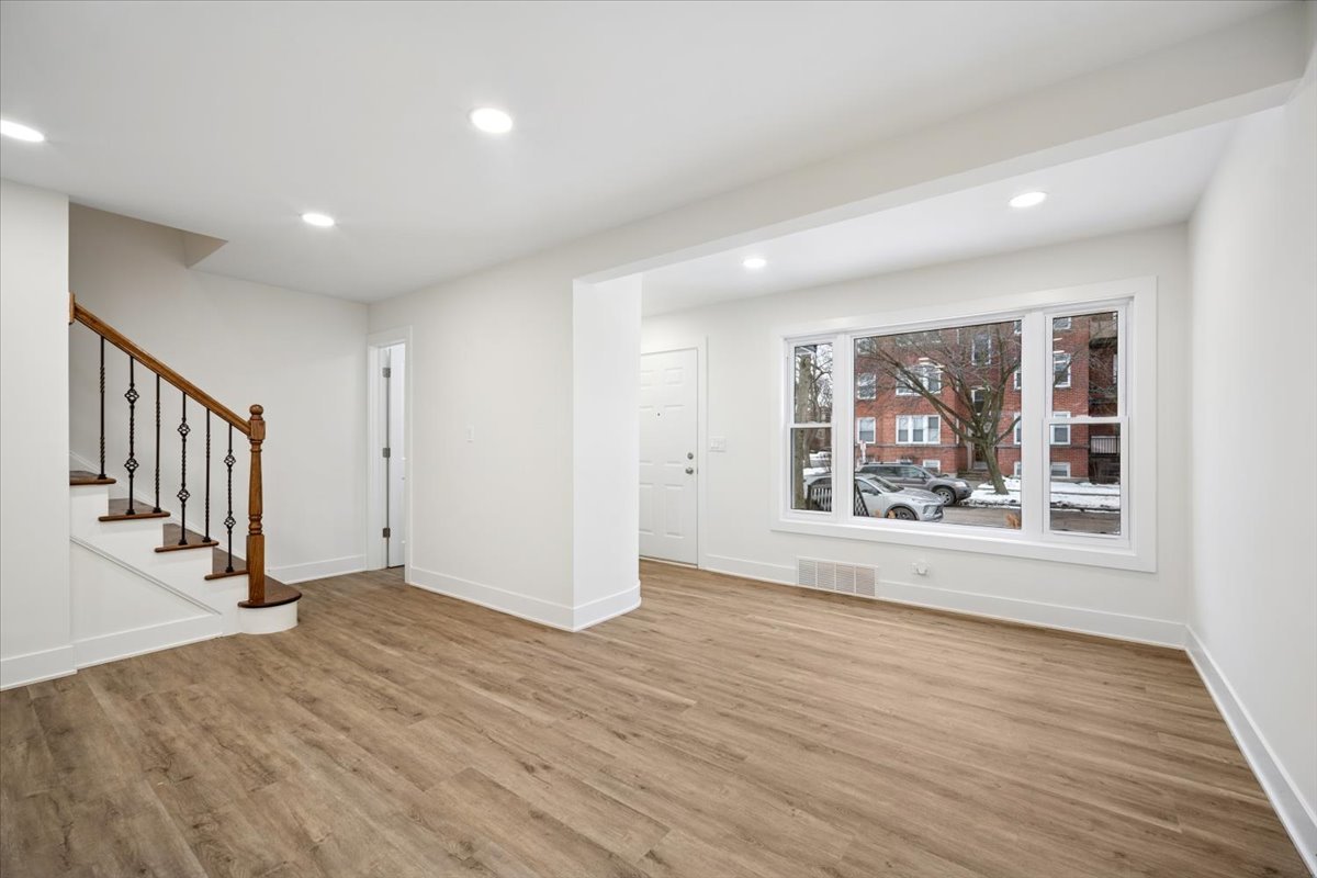 803 Brummel Street Evanston, IL 60202 - Photo 5 of 21 a view of an empty room with wooden floor and a window