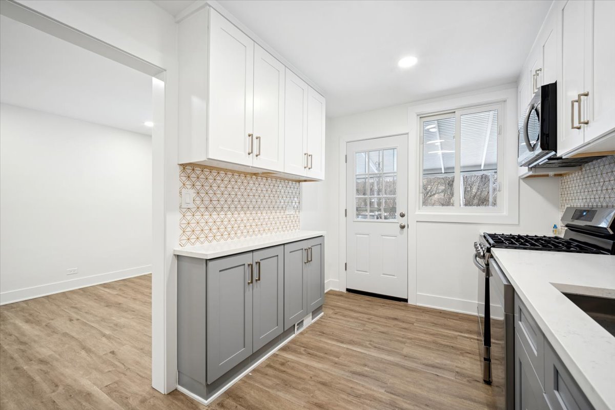 803 Brummel Street Evanston, IL 60202 - Photo 8 of 21 a kitchen with granite countertop a sink stove and cabinets