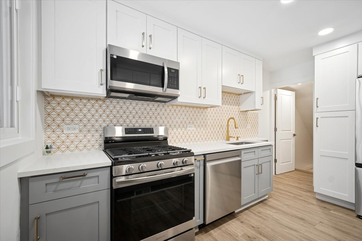 803 Brummel Street Evanston, IL 60202 - Photo 9 of 21 a kitchen with cabinets stainless steel appliances and wooden floor
