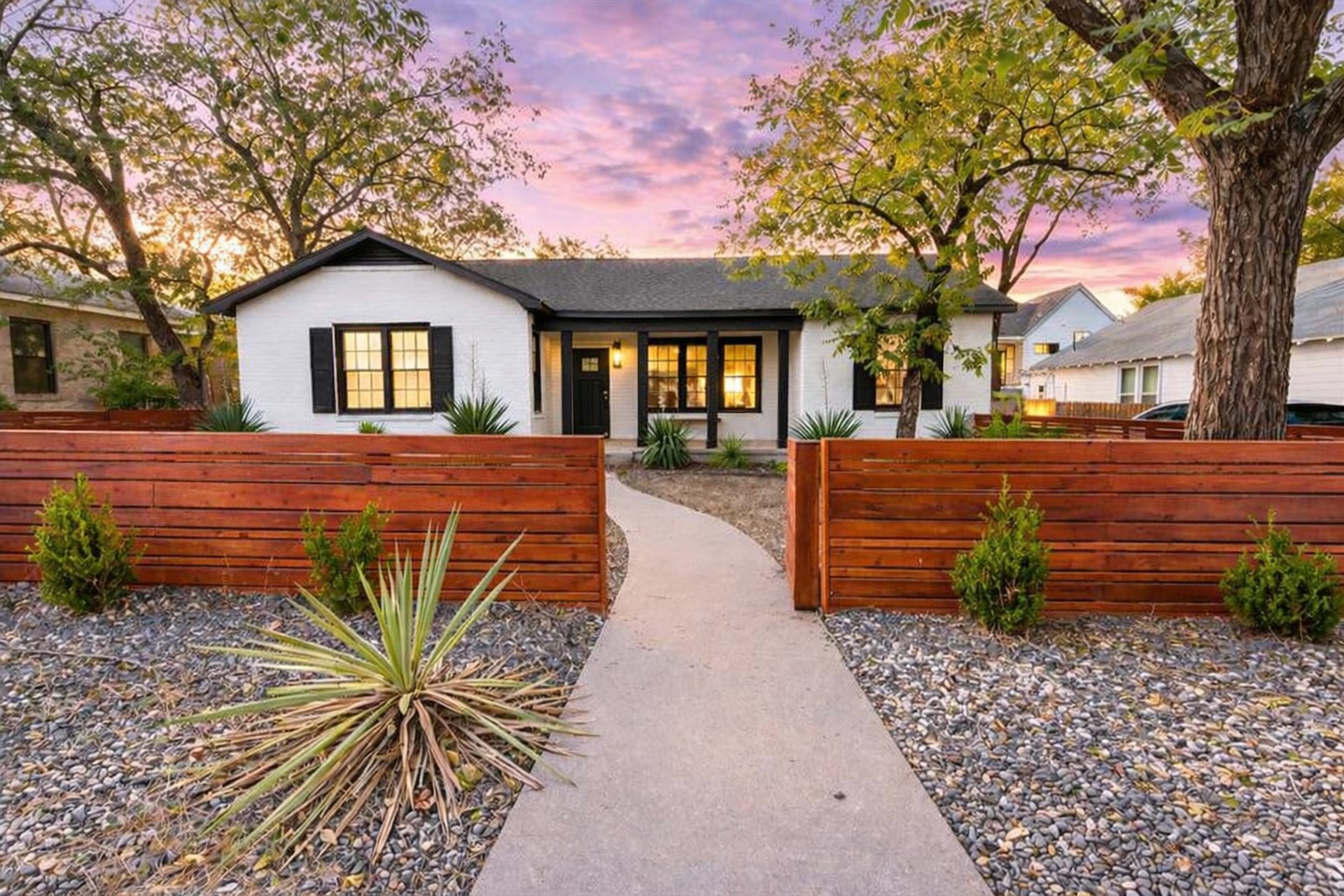 2106 Eva Street Austin, TX 78704 - Photo 1 of 13 a front view of a house with garden