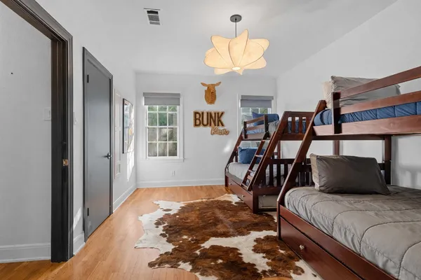 a bedroom with a bed and wooden floor