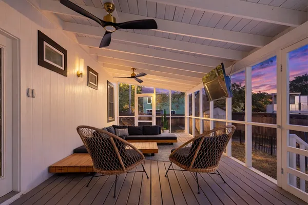 a view of a balcony with furniture and wooden floor