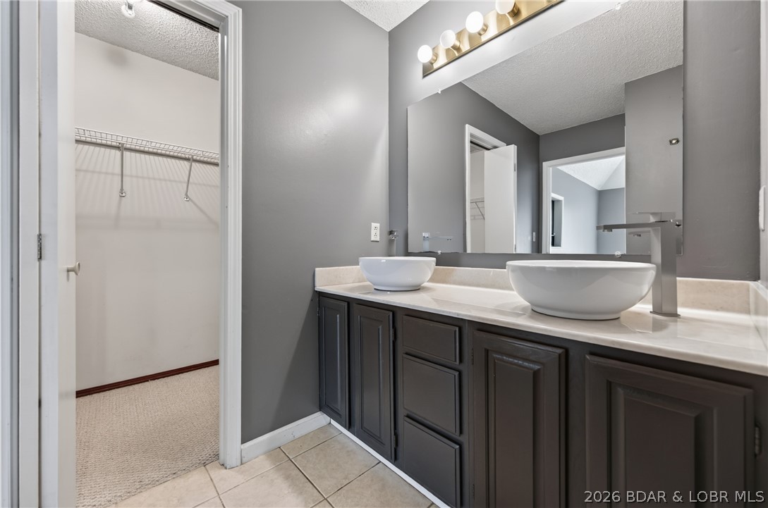 1889 Bittersweet Road Lake Ozark, MO 65049 - Photo 20 of 69 Primary double vanity and walk in closet.