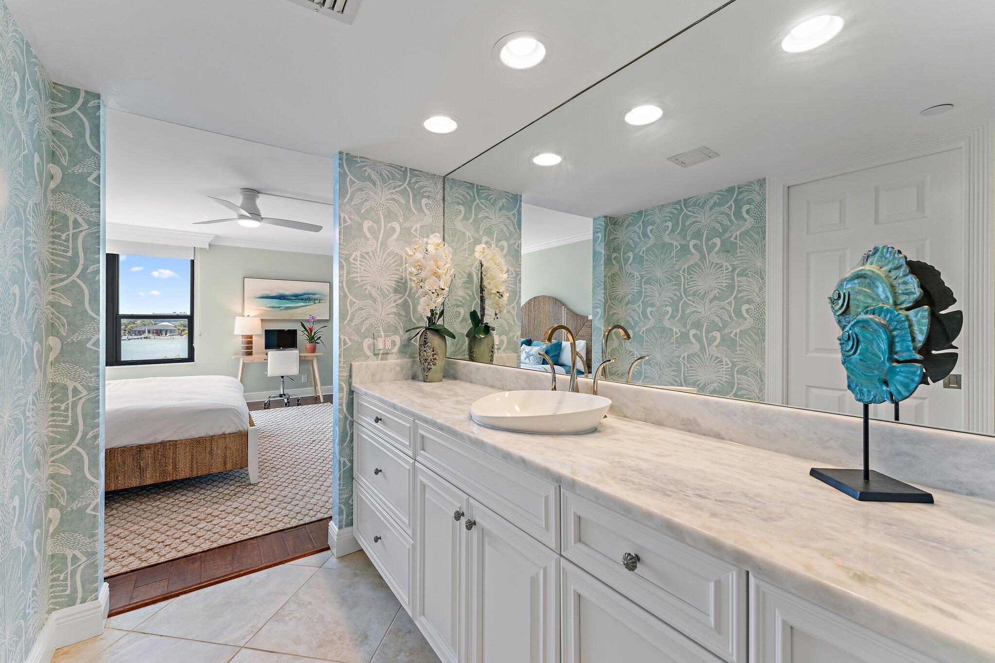 19670 South Beach Road, Unit B303 Jupiter, FL 33469 - Photo 48 of 104 a spacious en suite bathroom with a granite countertop sink and a mirror