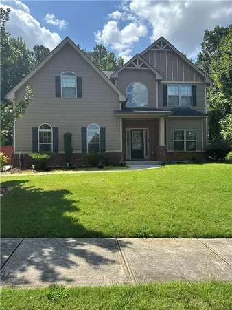 a front view of house with yard and green space