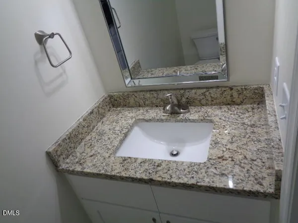a white toilet sitting next to a sink