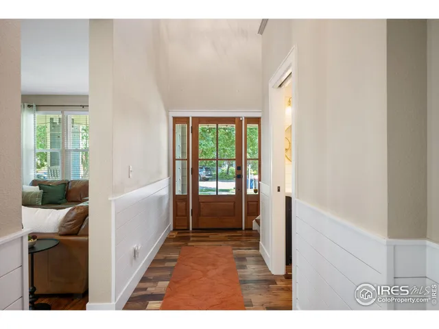 a view of hallway with furniture and a window