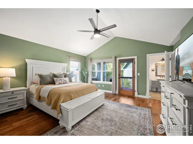 a spacious bedroom with a large bed and a chandelier