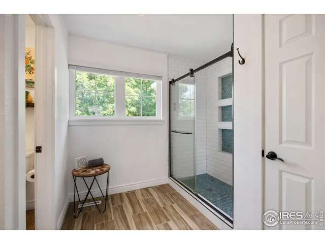 a bathroom with a shower and a sink