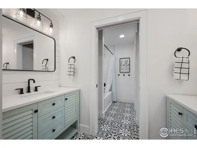 a bathroom with a toilet a sink a mirror and vanity