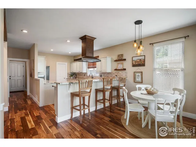 a dining room with furniture and wooden floor