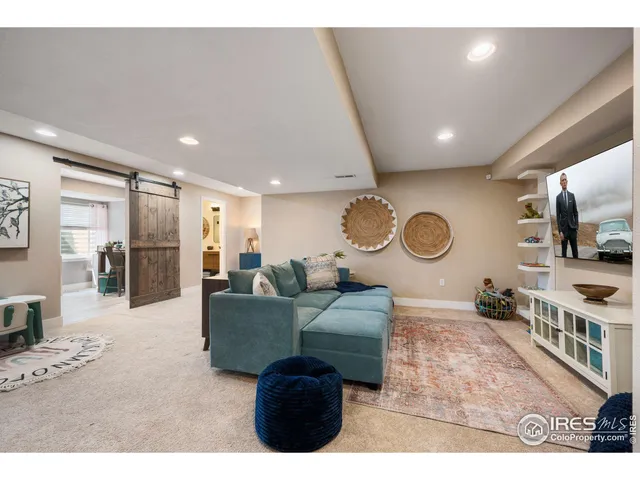 a living room with furniture a mirror and a clock