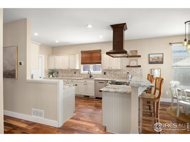 a kitchen with a stove and white cabinets