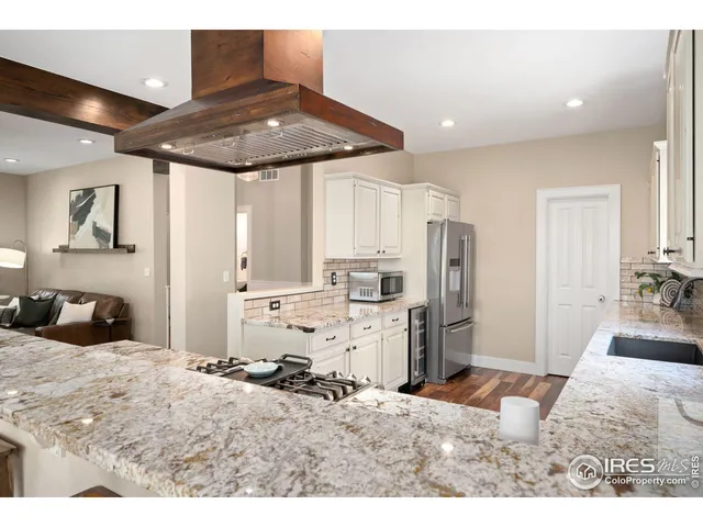 a kitchen with refrigerator and cabinets