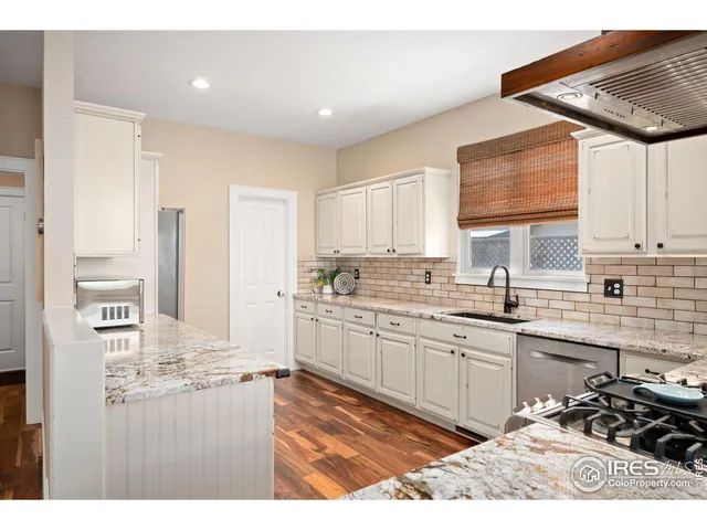 a kitchen with stainless steel appliances kitchen island granite countertop a sink and cabinets