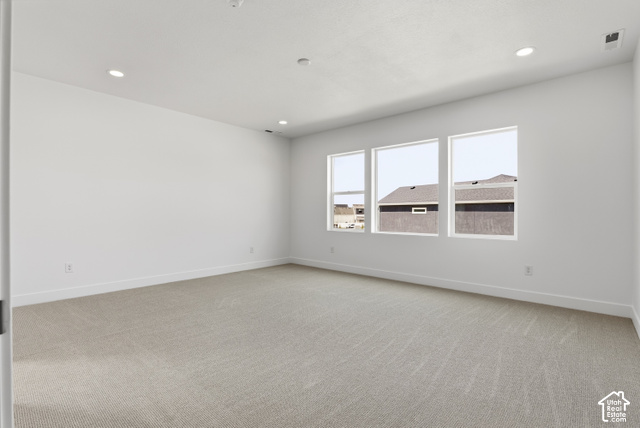79 South Crimson Way West, Unit 307 Mapleton, UT 84664 - Photo 31 of 42 Spacious room featuring light-toned carpet, recessed lighting, and a wall of three large windows