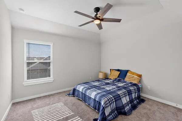 a bedroom with a bed and a tv on a dresser